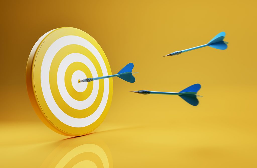 Business or success concept. Arrows aims at a dartboard target.